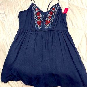 Navy shorts romper with adjustable tank straps. Red white and blue stitching.